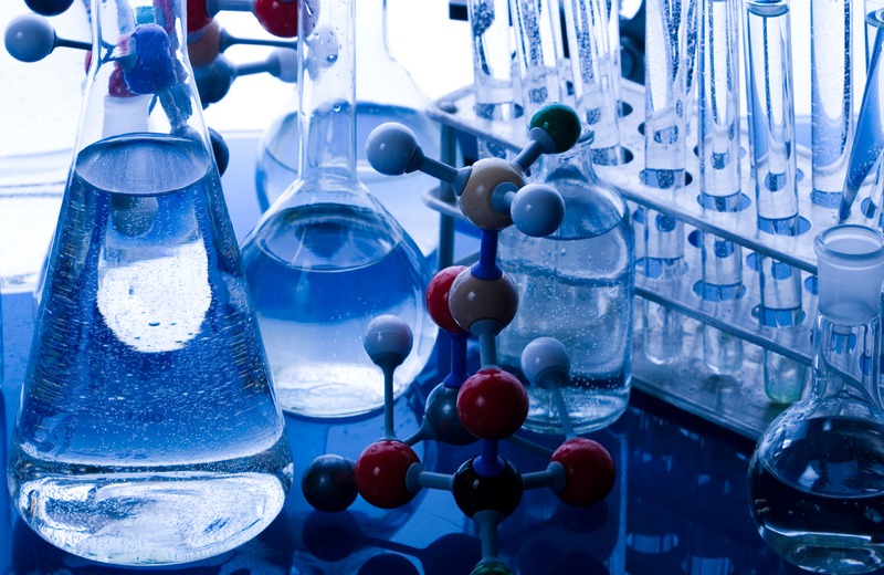 Quality control testing laboratory with chemists verifying chemical purity and batch standards